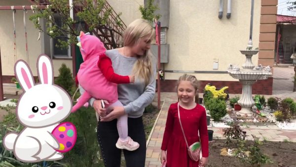 Julia and Eva play in garden and pick up chocolate eggs