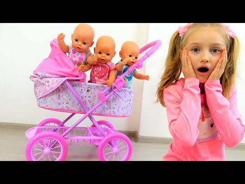 Polina playing with baby carriage for baby dolls