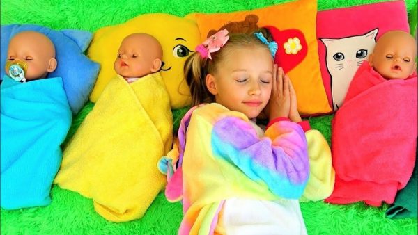 Polina playing with sleeping dolls